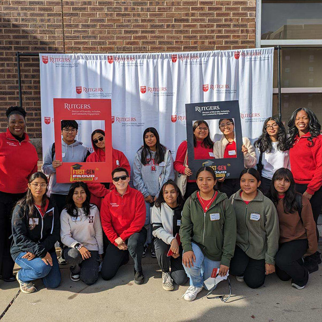 Group of students posing in front of Rutgers step and repeat image number 0